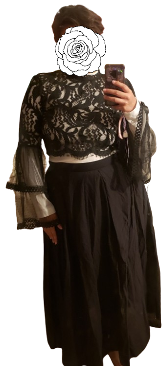 a long white long sleeve shirt, with a black blouse on top and a long black skirt. the outfit looks like a dress.