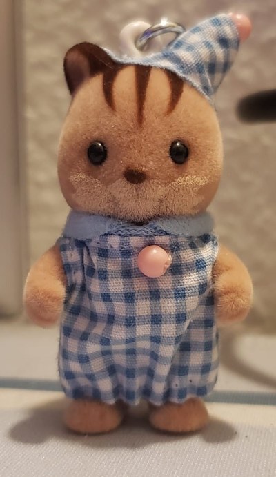 a squirrel calico critter keychain with a blue and white outfit